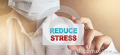 Reduce Stress words on a Card in Hands of Doctor. Healthcare relax stressfull job concept Stock Photo