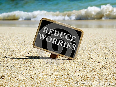 Reduce worries and stress concept. Sign on a sea cost Stock Photo