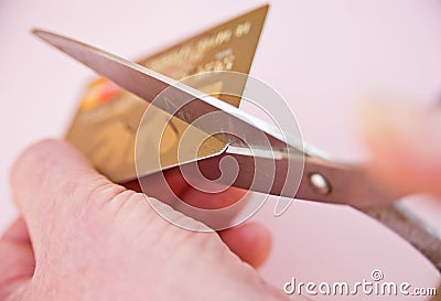 Reducing debt: cutting up credit card. Stock Photo