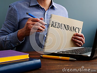 Redundancy concept. Man at the table holds papers. Stock Photo
