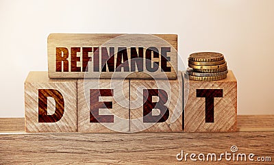 Refinance Debt text on a wooden blocks and cubes and stack of coins. Overdue debts redeem and refinancing financial banking Stock Photo