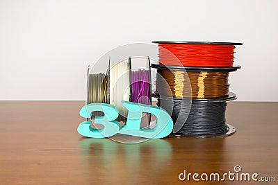 3D printing filament reels with text `3d` on wooden background Stock Photo