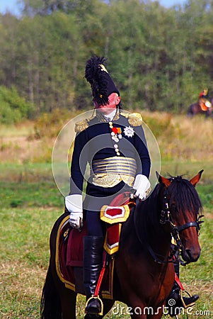 Reenactor dressed as Napoleonic war soldier rides a horse. Editorial Stock Photo