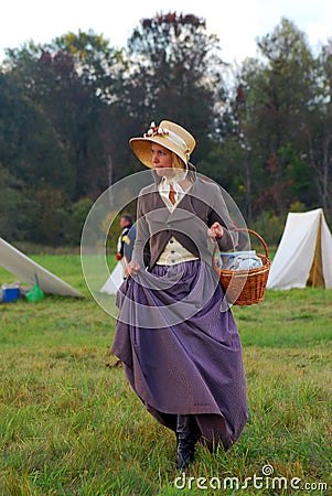 Reenactor woman portrait. She walks on green grass. Editorial Stock Photo