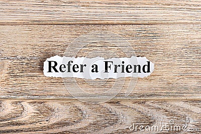 REFER A FRIEND text on paper. Word REFER A FRIEND on torn paper. Concept Image Stock Photo