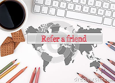 Refer a friend. White office desk with a cup of coffee, biscuits Stock Photo