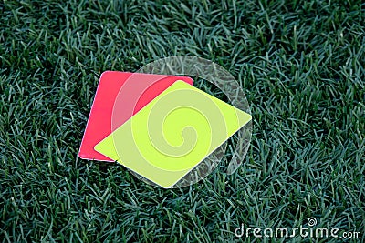 Referee soccer, football game, red and yellow cards on green grass. Two penalty cards for the referee Stock Photo