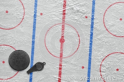 Referee whistle, the puck and hockey field Stock Photo