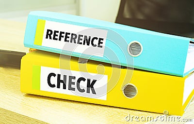 REFERENCE CHECKS on colourful folders on table Stock Photo