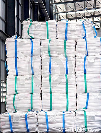 Refine sugar in white jumbo bag stack inside warehouse. Stock Photo