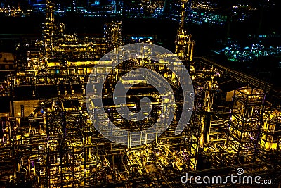 Refinery pipes and buildings with lights at night Stock Photo