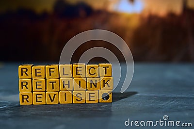 Reflect - Rethink - Revise on wooden blocks. Cross processed image with bokeh background Stock Photo