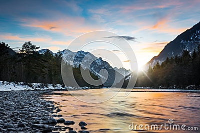 Reflecting colors of sunset clouds in rural river Stock Photo