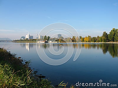 Reflecting Donaustadt skyline with tall apartment buildings in Danube river, Vienna - Austria Stock Photo