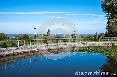 Reflecting water and fence at the Muur or wall, a step hill at Geraardsbergen, Flemish Region, Belgium Stock Photo