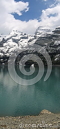 Reflection of the Alps in Oeschinensee lake , Switzerland Stock Photo