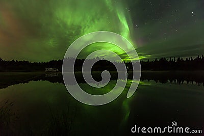 Reflection of Aurora Borealis over Olnes pond in Fairbanks, Alaska Stock Photo