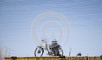 Reflection of a bicycle parked on a platoon pier on a lake Stock Photo