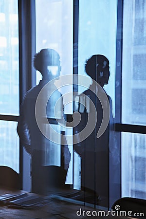 Reflection of businessman looking outside the window Stock Photo