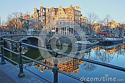 Reflection of crooked and colorful heritage buildings along Brouwersgracht Canal and with Lekkeresluis Bridge on the left, Amsterd Stock Photo