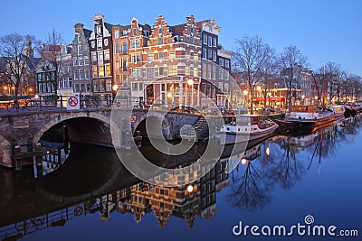 Reflection of crooked and colorful heritage buildings along Brouwersgracht Canal and with Lekkeresluis Bridge on the left, Amsterd Stock Photo