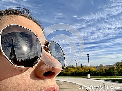 Reflection of the Eiffel Tower in a person glasses. Reflection of the Paris tower in a woman glasses Stock Photo