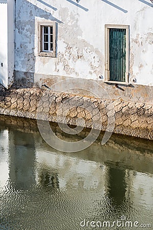 Reflection of green door leading into the water Stock Photo