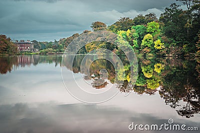 Reflection of mansion in the trees Stock Photo
