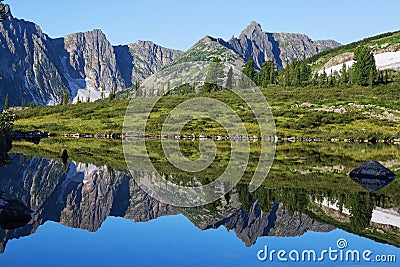 Reflection of the mountain on water, mirror image of mountains in water Stock Photo