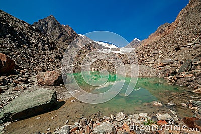 Reflection of mountains in water, Aktru glacier, Altai Republic, Siberia, Russia. Stock Photo