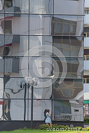 Reflection of a multi-storey building in the glass facade of a modern skyscraper Editorial Stock Photo