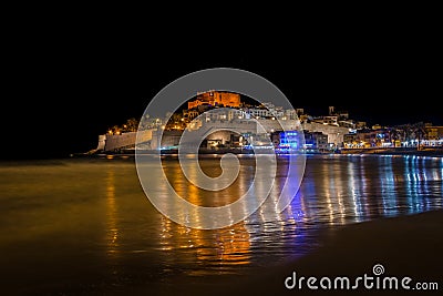 Reflection of the old town of Peniscola at night, Peniscola, Castellon, Spain Stock Photo