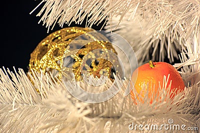 The reflection of the orange tangerine to Golden on the Christmas tree, both items are on eating white. decorations before Stock Photo