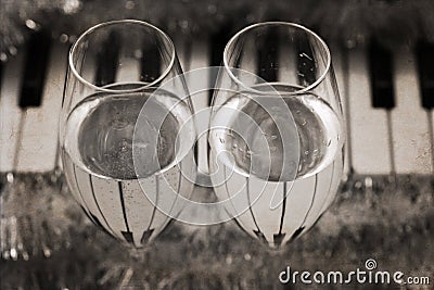 Reflection of piano keys in two wine glasses, pianoforte Stock Photo