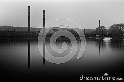 Reflection of the plant and TPP pipes on the water surface. Stock Photo
