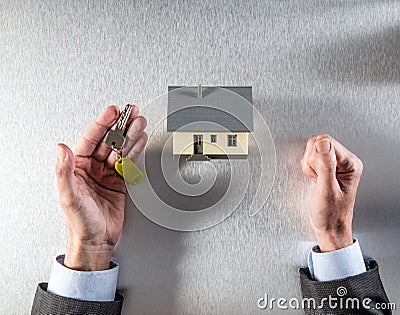 Reflection for renting, selling or buying house in businessman hands Stock Photo