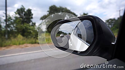 Reflection side rear view car mirror on road Stock Photo