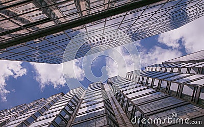 Reflection of clouds in glass walls of skyscrapers in the big city and the blue sky with white clouds Stock Photo