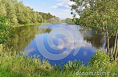Reflection of the sky in a round lake Stock Photo
