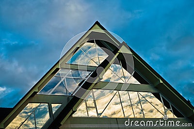 Reflection of a sky in a triangle glass shape on a building at Bled Stock Photo