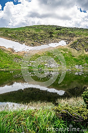 Reflection in the water of a mountain lake Stock Photo