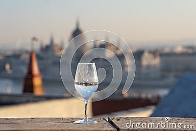 Reflection in wine glass of Hungary Paliament hazy figure in the background Stock Photo