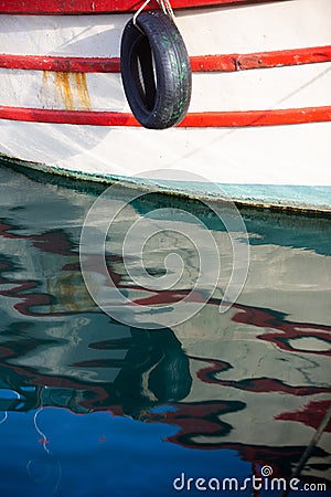 Reflection of a wooden fishing boat in water Stock Photo