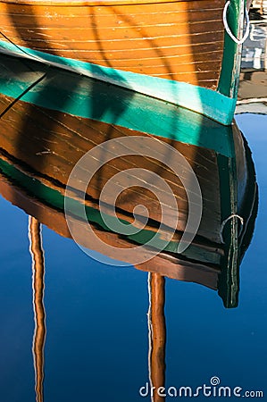 Reflections of a beautiful wood boat in the sun. Stock Photo