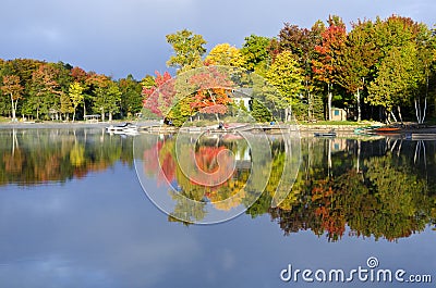 Reflections of Fall Colors on a Tranquil Lake Stock Photo