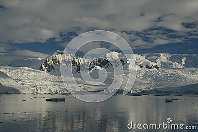 Reflections of glacial icefalls and mountains Stock Photo