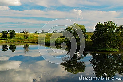 Reflections on an Iowa Farm Pond Stock Photo