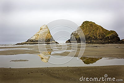 Reflections of the monoliths at Heceta Head State park Stock Photo