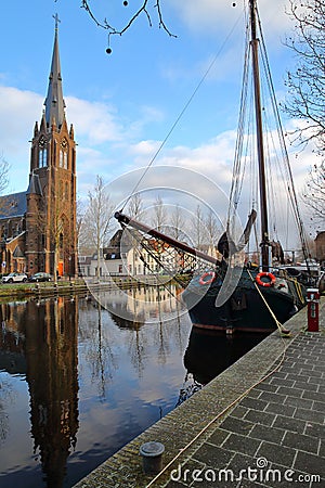 Reflections of the Roman Catholic Saint Lawrence Laurentius church located along herengracht street in Weesp, North Holland, Net Editorial Stock Photo
