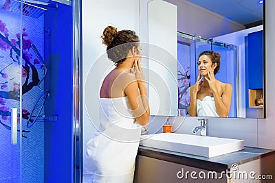 Refreshed woman looking at herself in a mirror Stock Photo